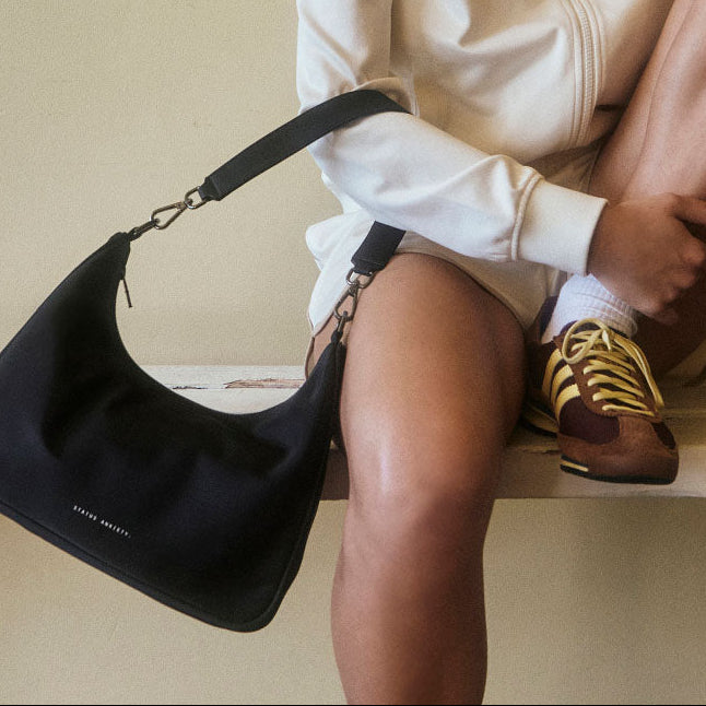 https://cdn.shopify.com/s/files/1/0214/8218/files/status-anxiety-bag-poly-fleur-black-5-lifestyle-img.jpg?v=1770763823