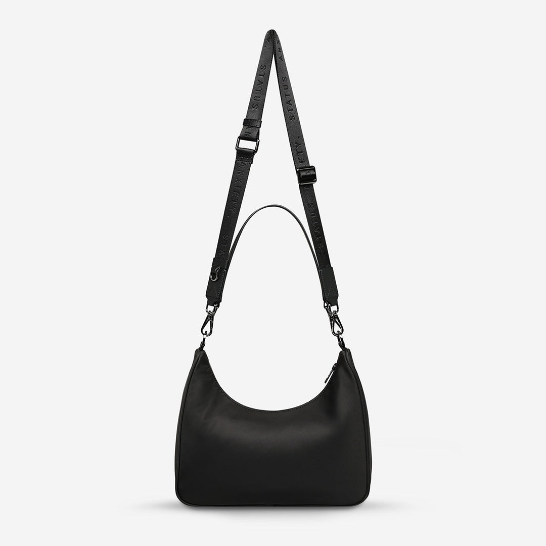 https://cdn.shopify.com/s/files/1/0214/8218/files/status-anxiety-bag-poly-fleur-black-back.jpg?v=1771287950