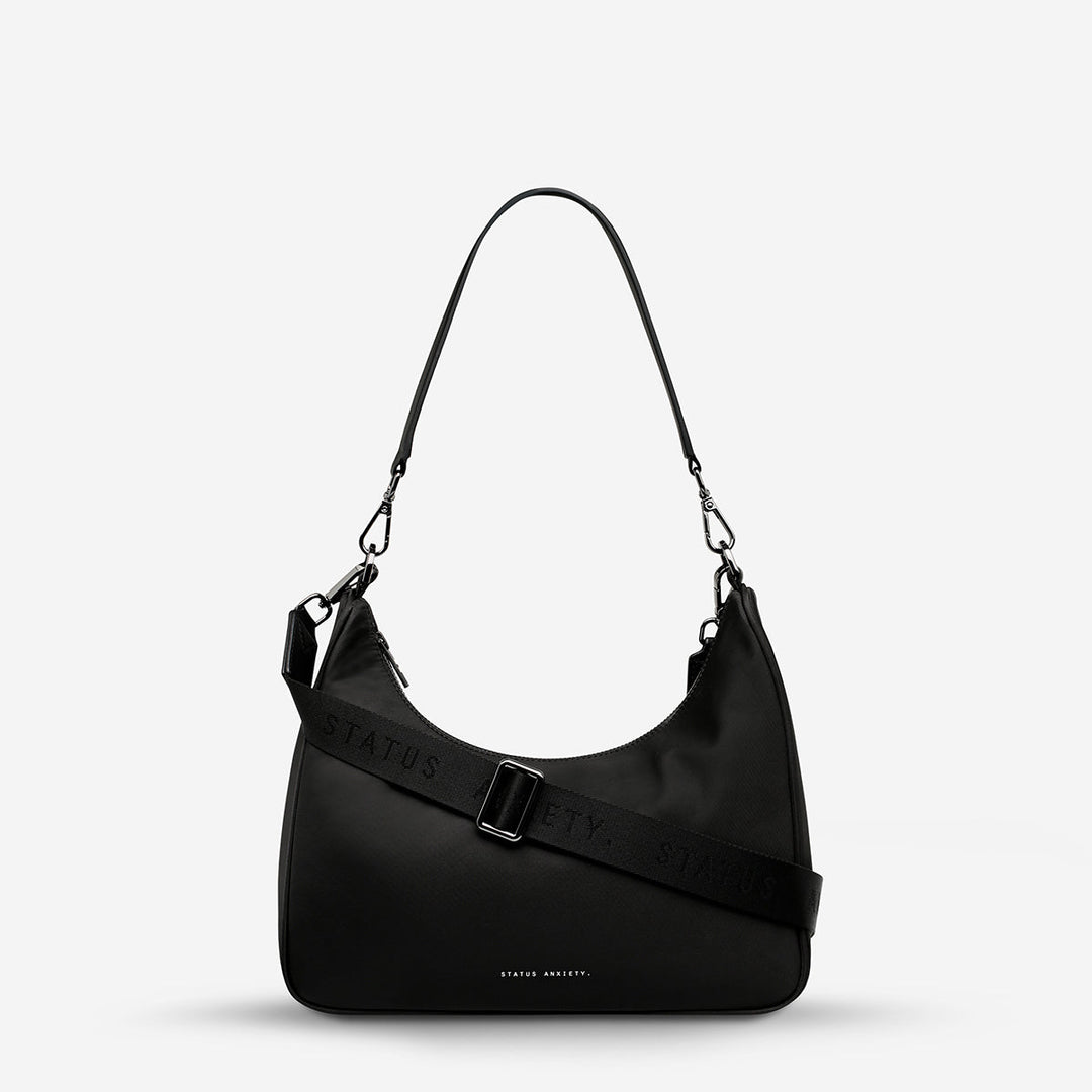 https://cdn.shopify.com/s/files/1/0214/8218/files/status-anxiety-bag-poly-fleur-black-front-wrapped.jpg?v=1770763823
