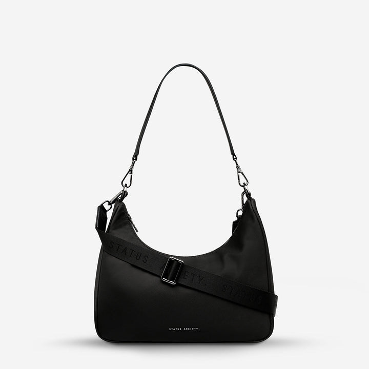 https://cdn.shopify.com/s/files/1/0214/8218/files/status-anxiety-bag-poly-fleur-black-front-wrapped.jpg?v=1770763823