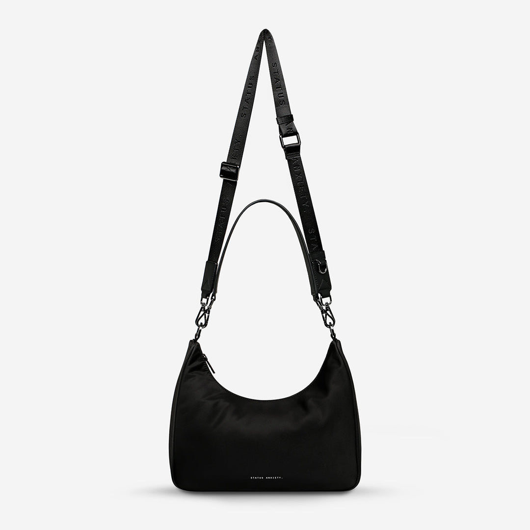 https://cdn.shopify.com/s/files/1/0214/8218/files/status-anxiety-bag-poly-fleur-black-front.jpg?v=1753978538