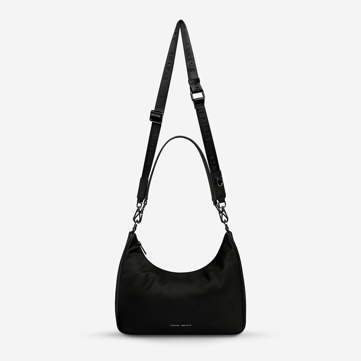https://cdn.shopify.com/s/files/1/0214/8218/files/status-anxiety-bag-poly-fleur-black-front.jpg?v=1753978538